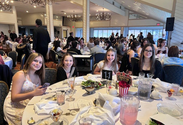 4 FCCLA students at a banquet table