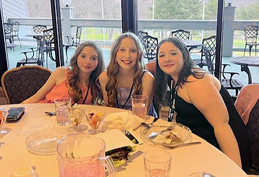 3 FCCLA students at a banquet table