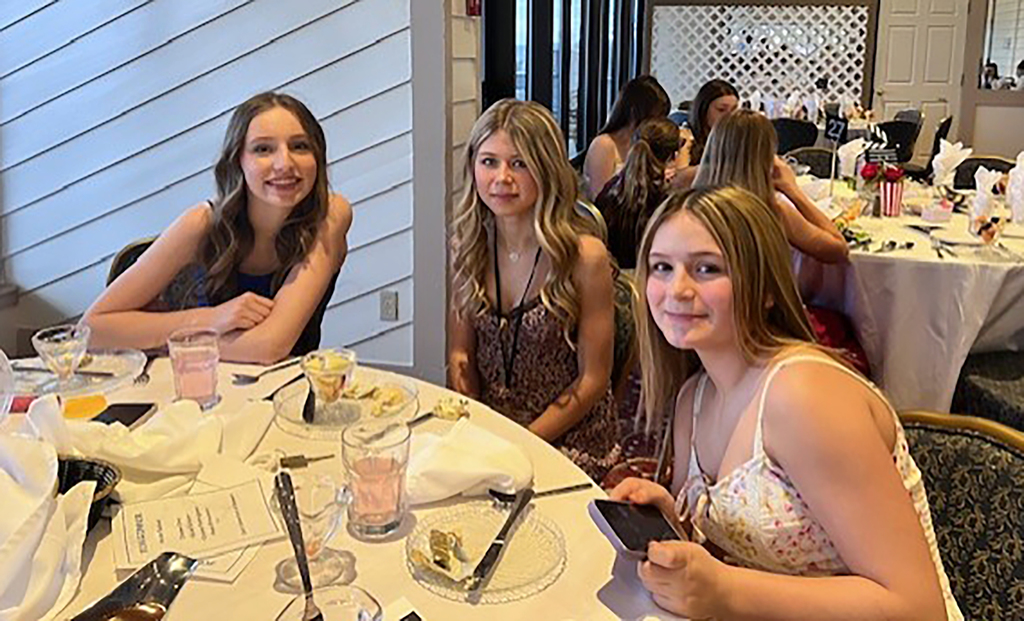 3 FCCLA students at a banquet table