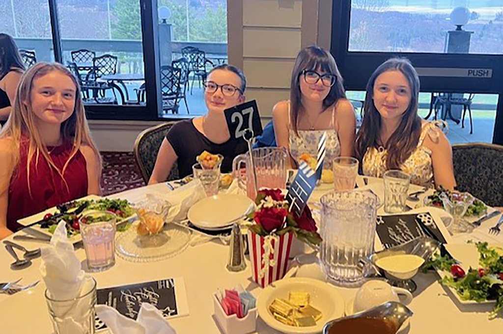 4 FCCLA students at a banquet table