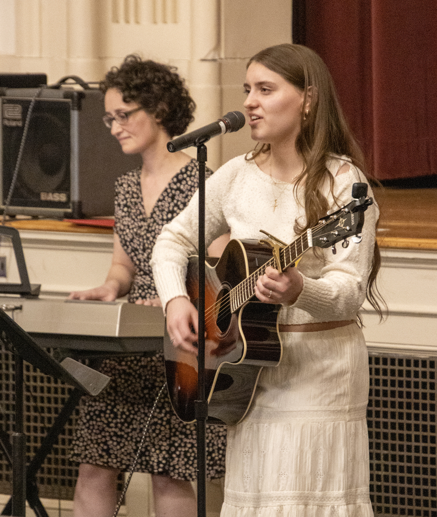 Eliza Cook playing guitar and singing