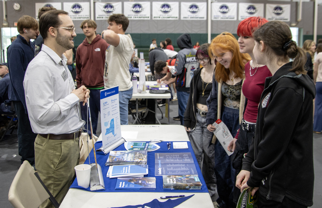 students talk to a college representative