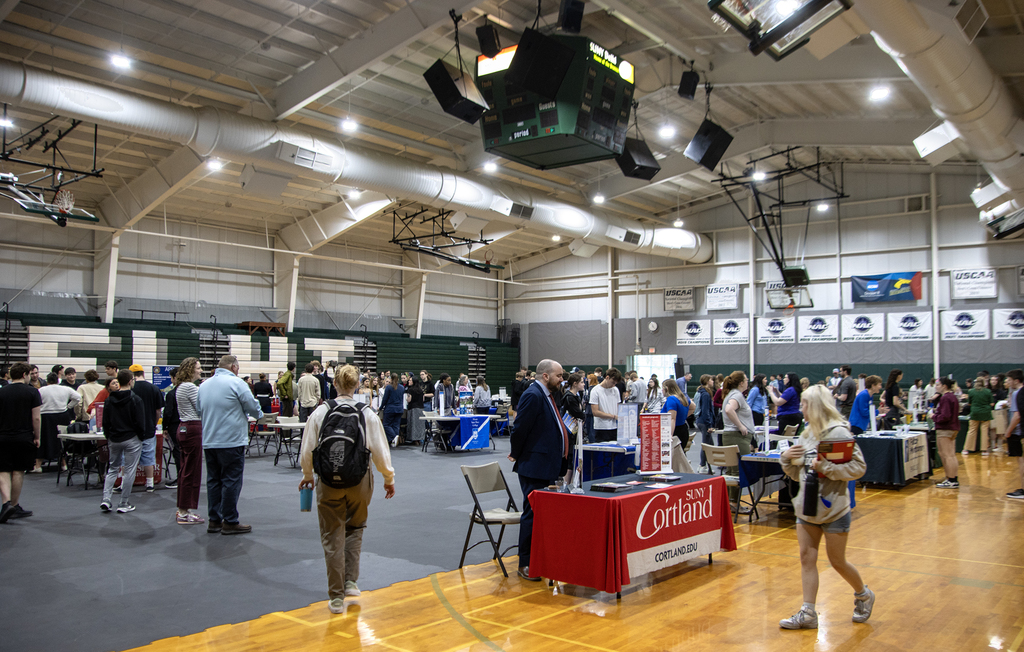 wide view of college fair in gymnasium