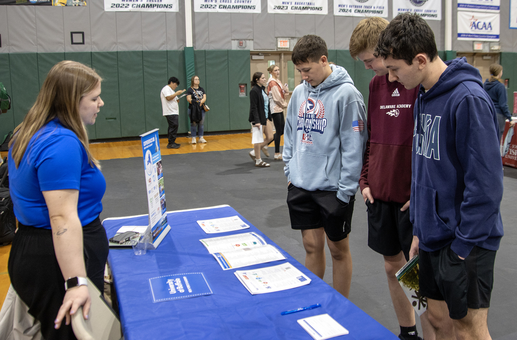 students talk to a college representative