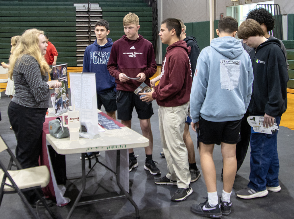 students talk to a college representative