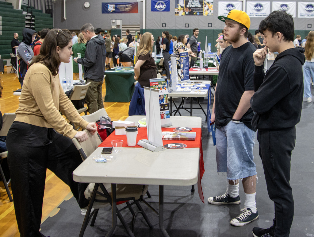 students talk to a college representative