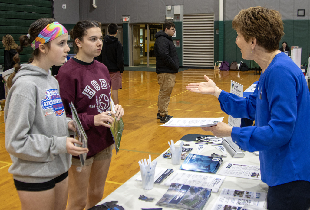 students talk to a college representative