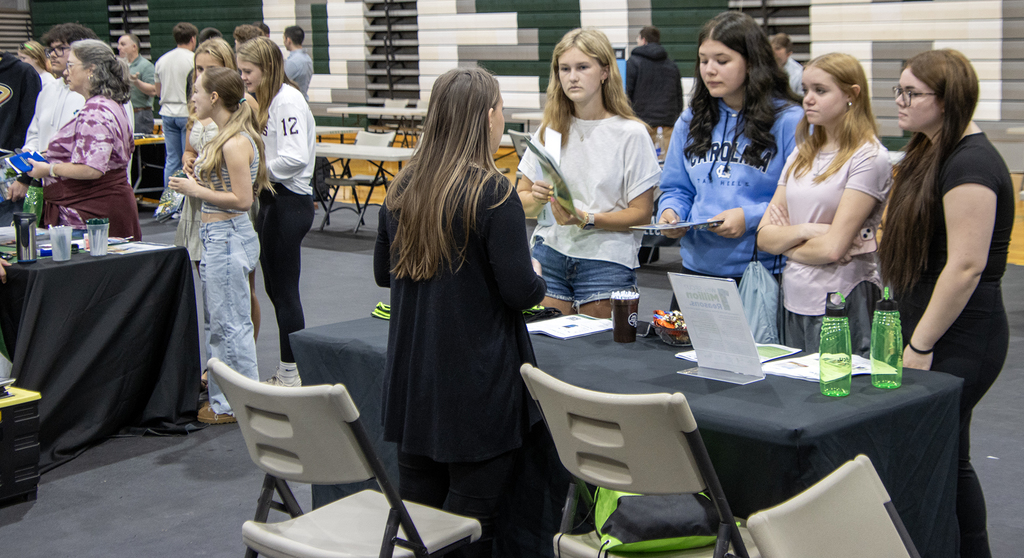 students talk to a college representative