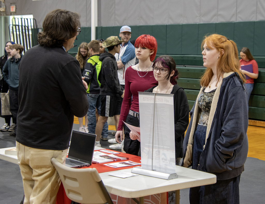students talk to a college representative