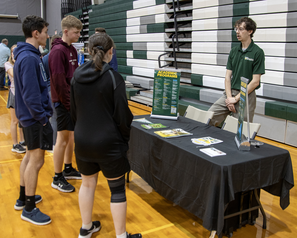 students talk to a college representative