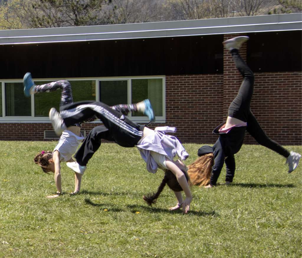 3 students doing handflips