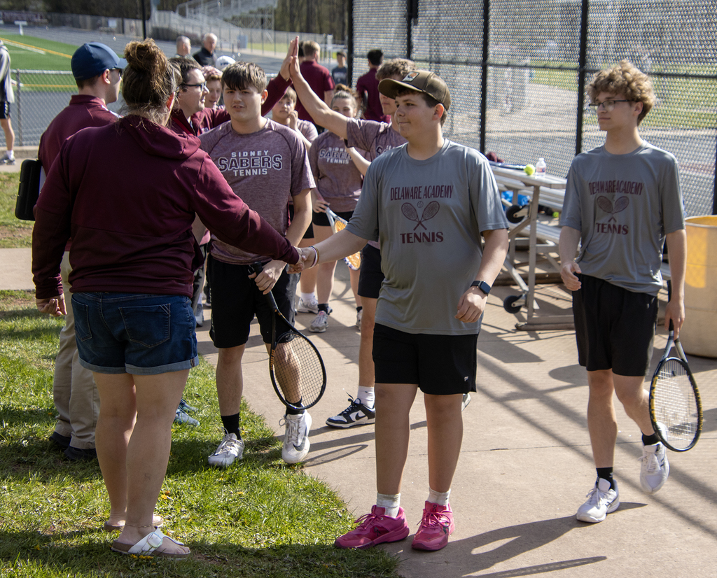 tennis players shake hands before match