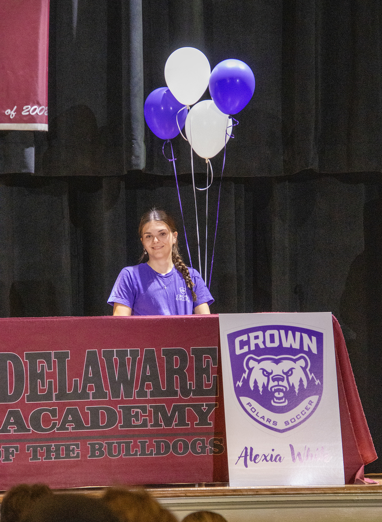 Alexia White with Crown College poster