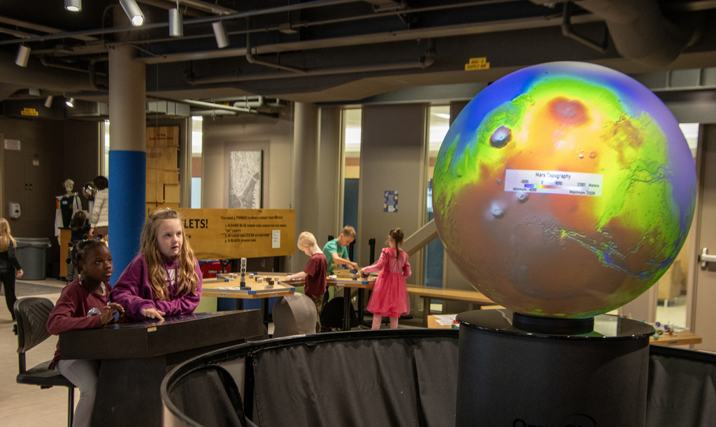 stuents with the giant globe exhibit