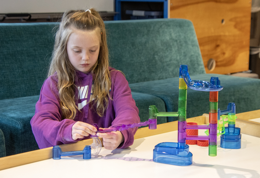 student building a marble run