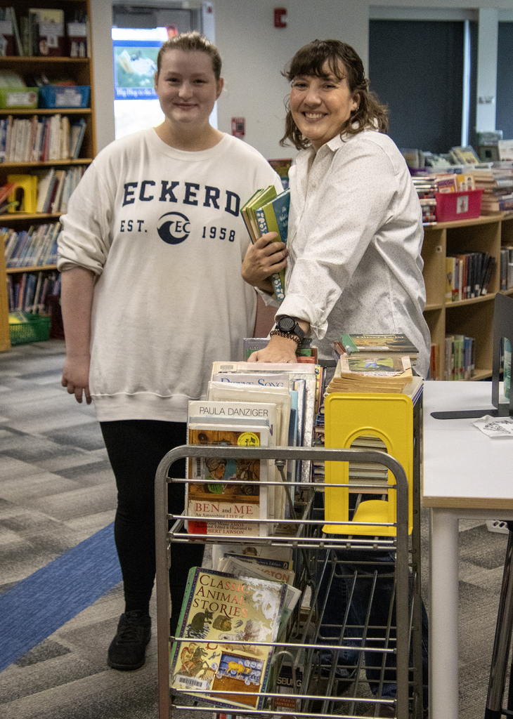 stuent with Ms. Oliver in the library