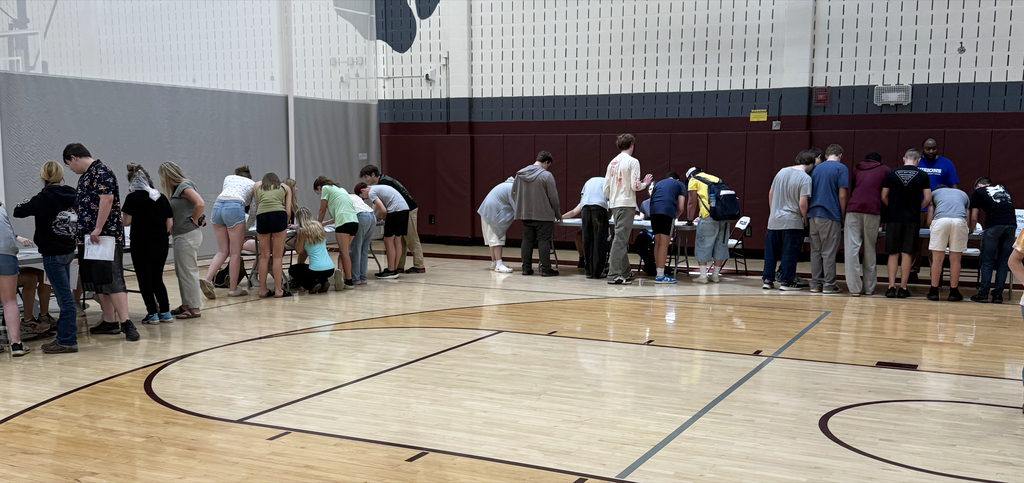 students gathered around tables