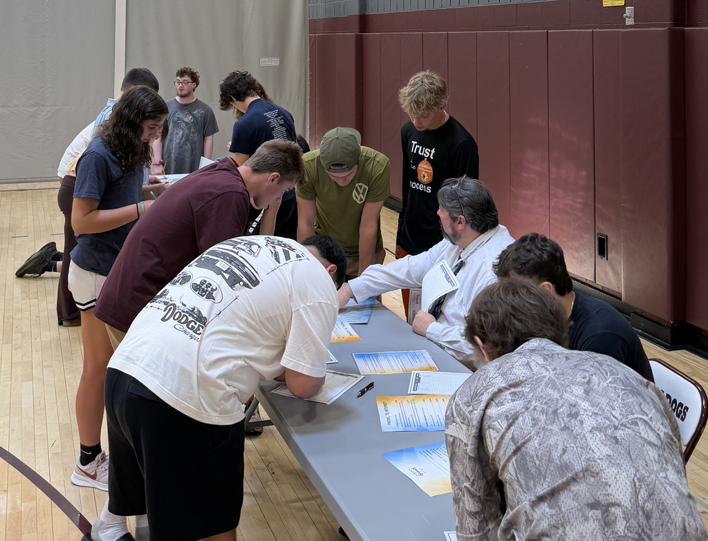students gathered around tables, Mr. All instructing