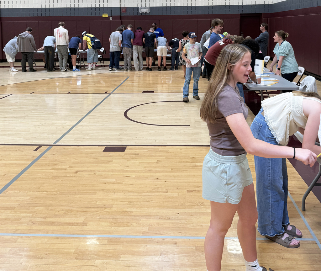 students gathered around tables