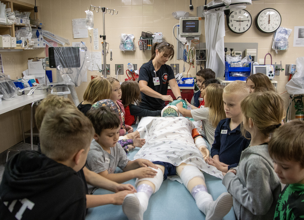 students practice bandaging on a dummy in the trauma room