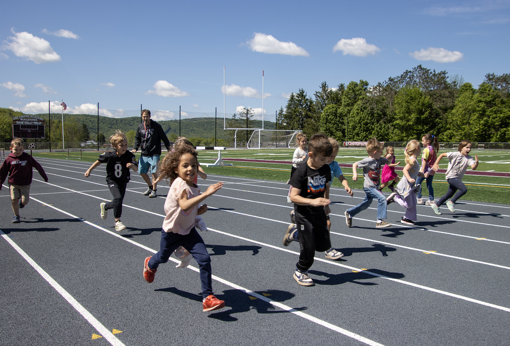 elementary students running on the track