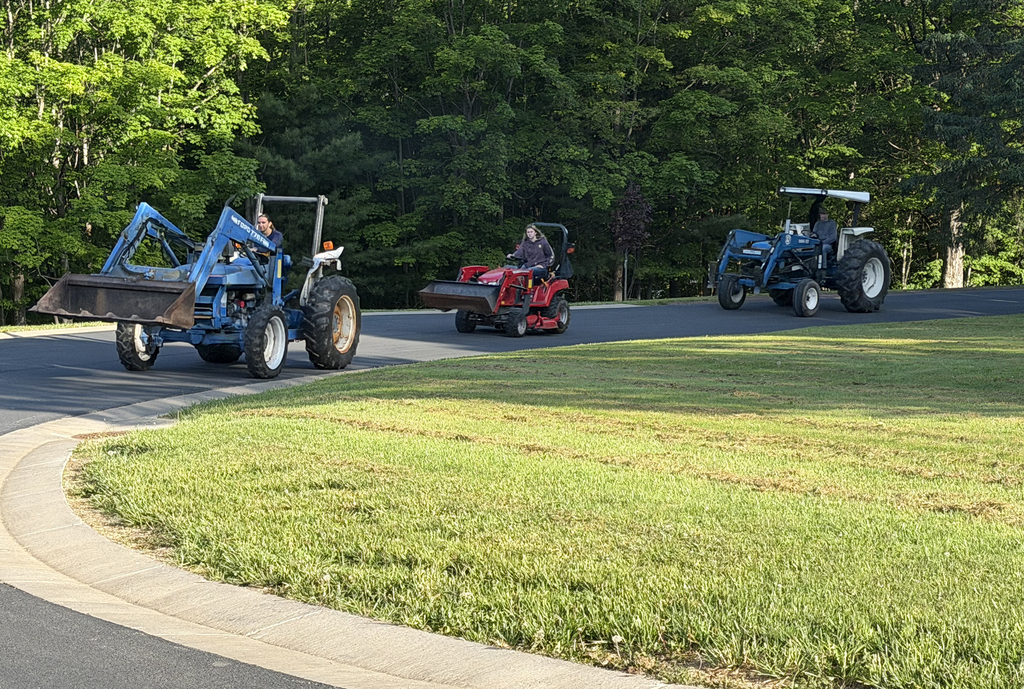 3 tractors heading up the school drive