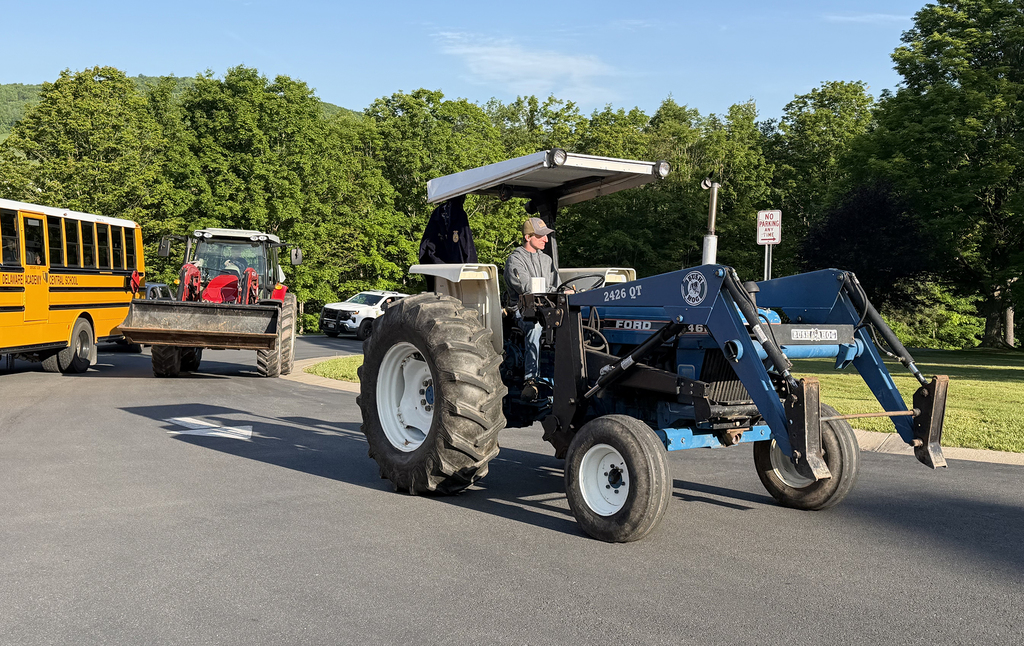 Student on blue tractor