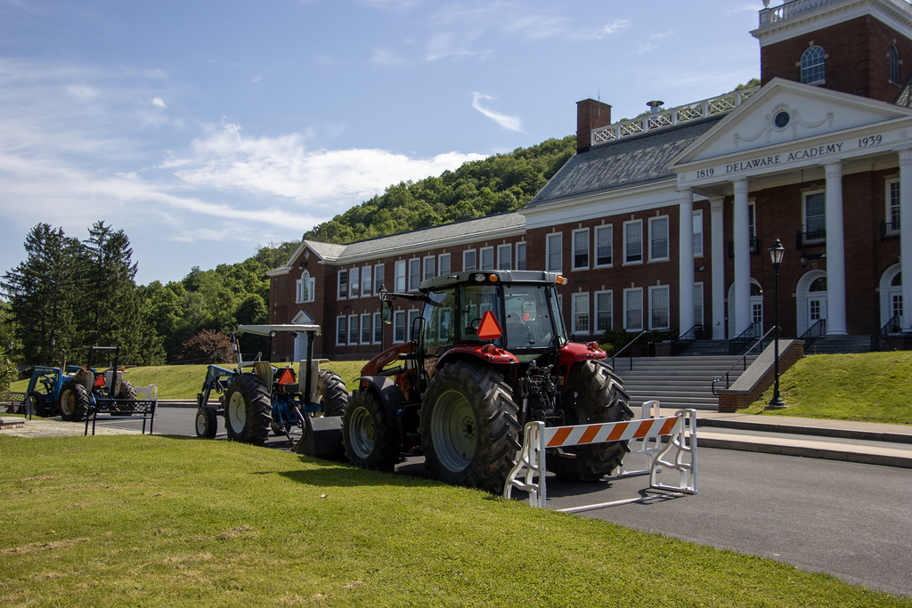 3 tractors parked in front of school
