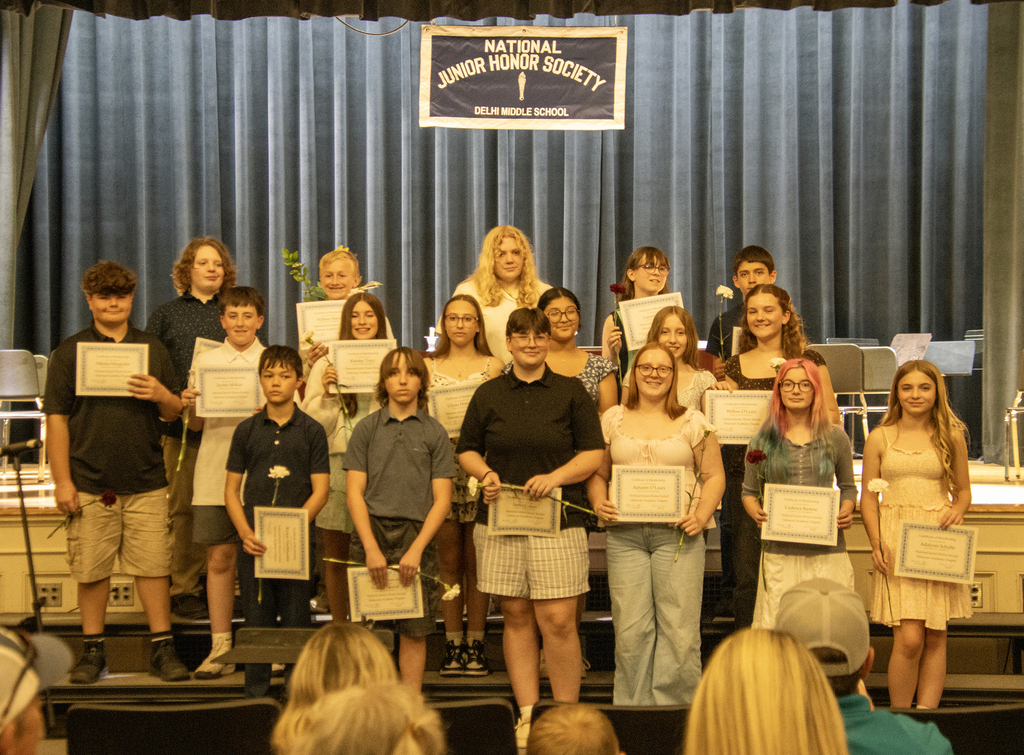 new members of the National Junior Honor Society pose with their certificates