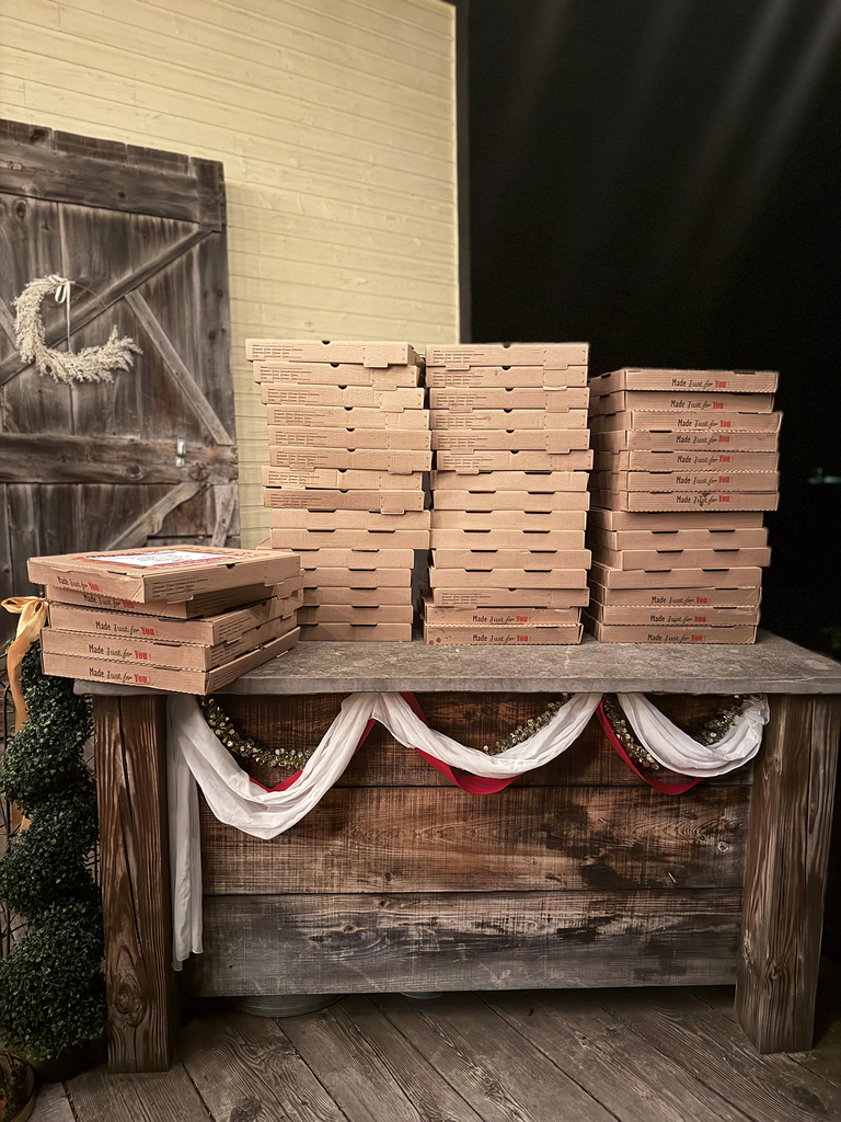 Piles of pizzas in boxes on a table