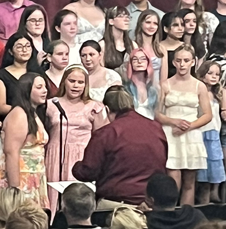 Miss Lamb conducts, girls singing solos