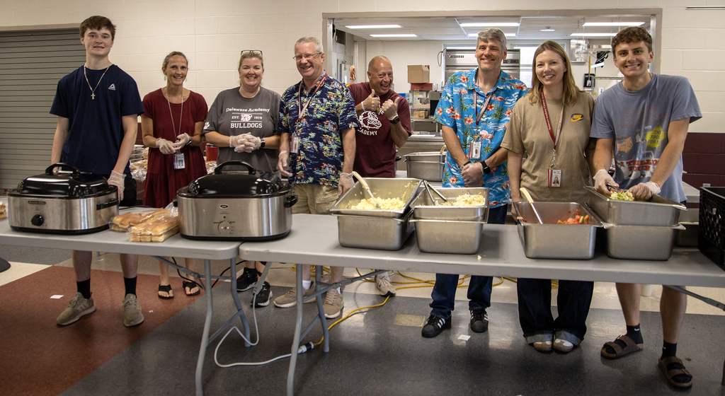 teachers and staff man the barbeque table