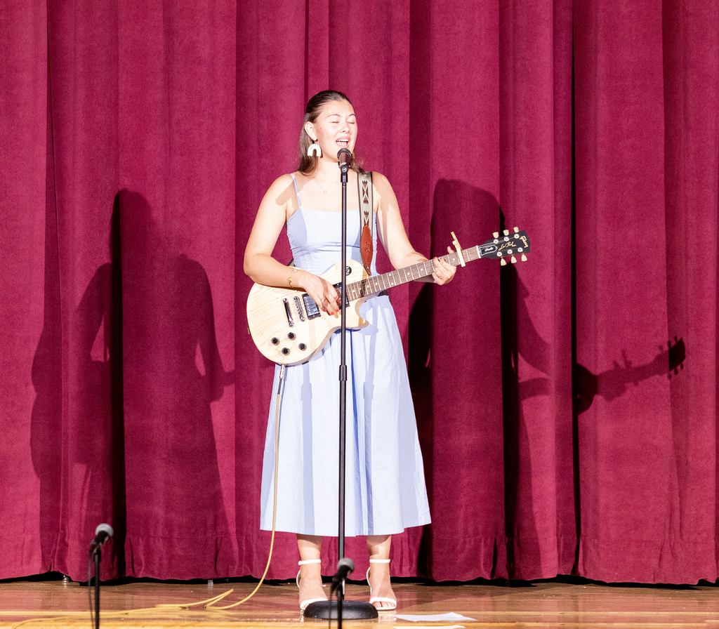 Paisley Smith singing and playing guitar