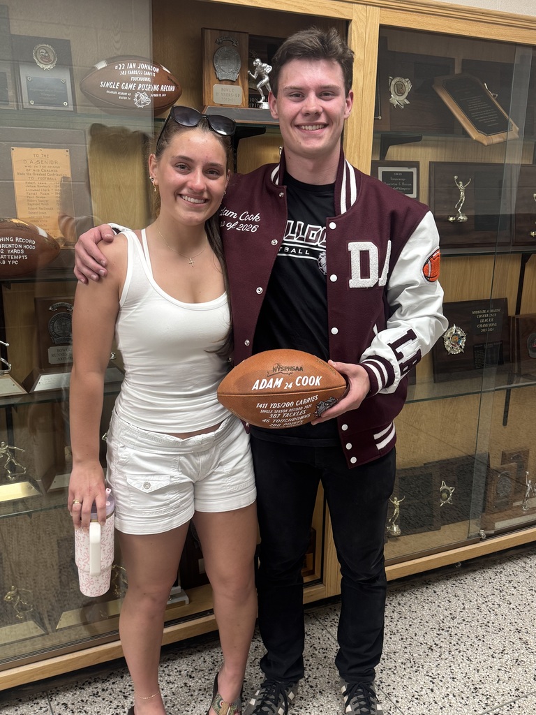 Adam poses with the football and his sister