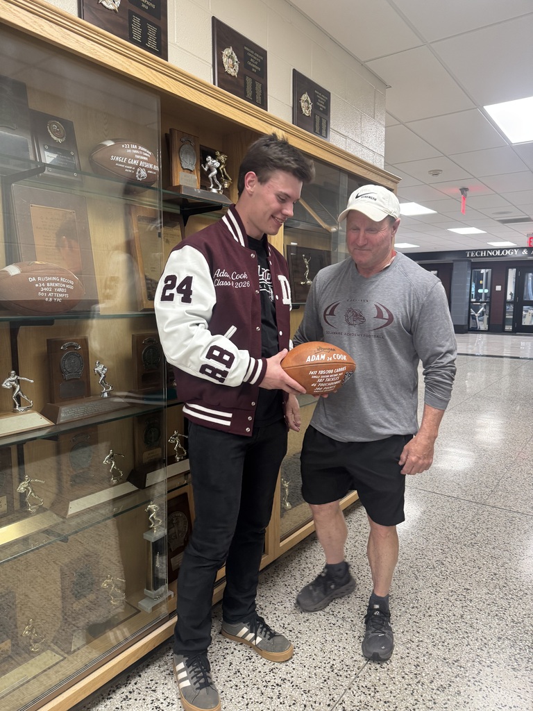 Adam and Coach Neumann look at football