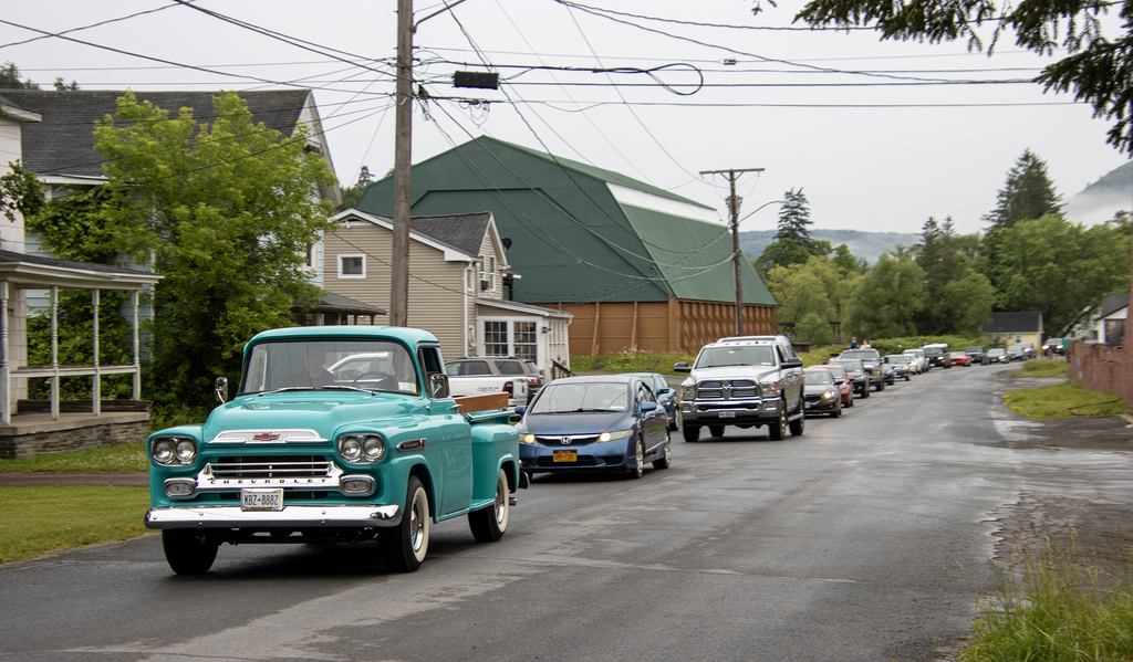 vintage truck leading the other cars in the parade
