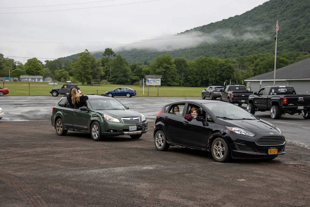 students in their cars driving around the legion parking lot
