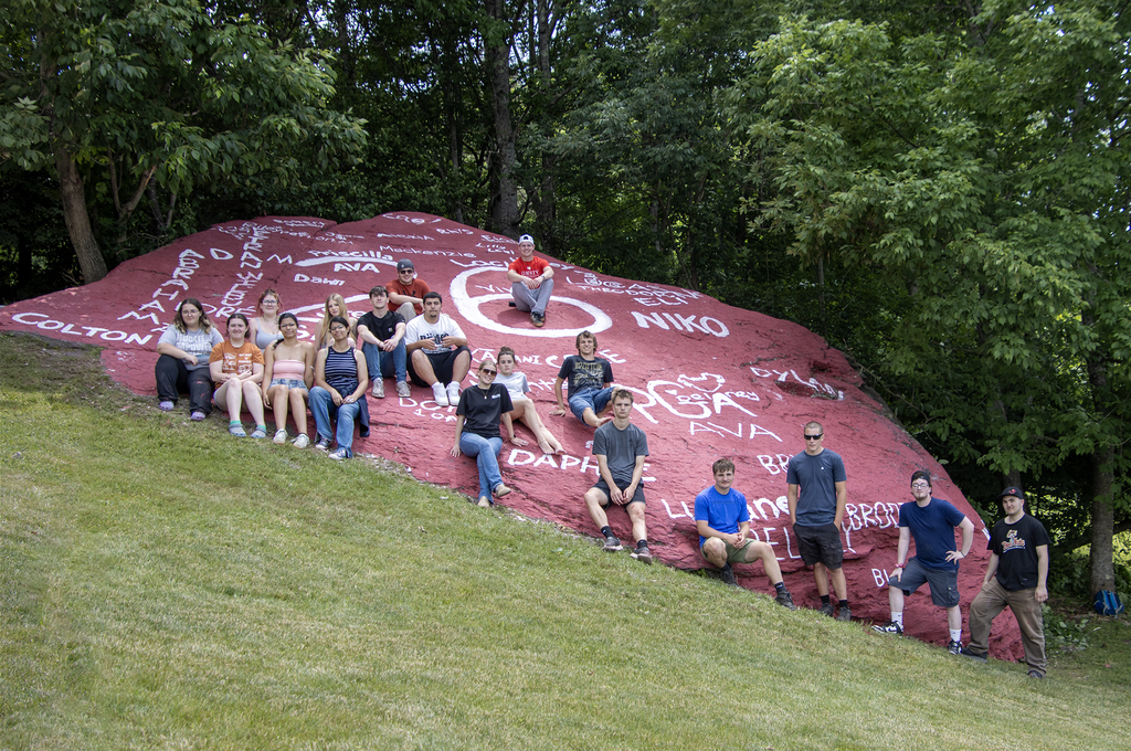 Seniors pose in front of the painted rock