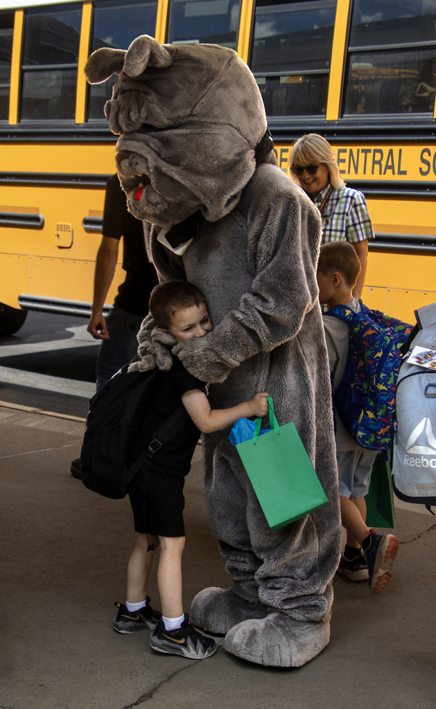 student hugs Bulldog mascot
