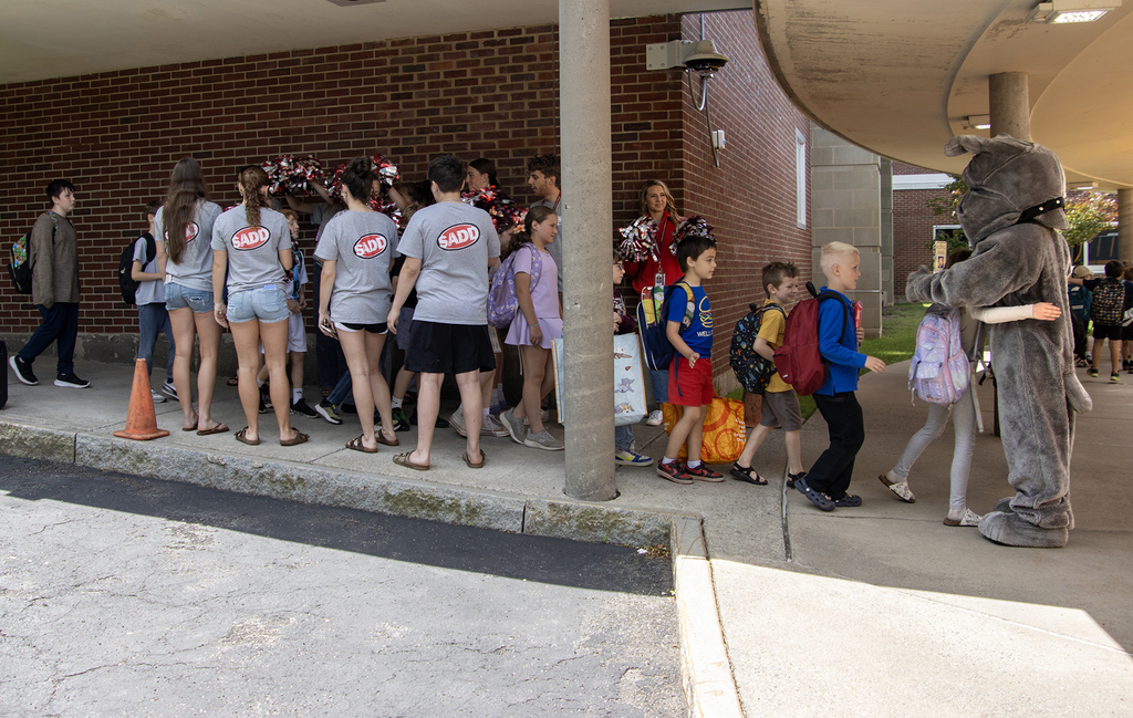 SADD students cheer for elementary students as they leave the school building for the day; Bulldog mascot also greets them
