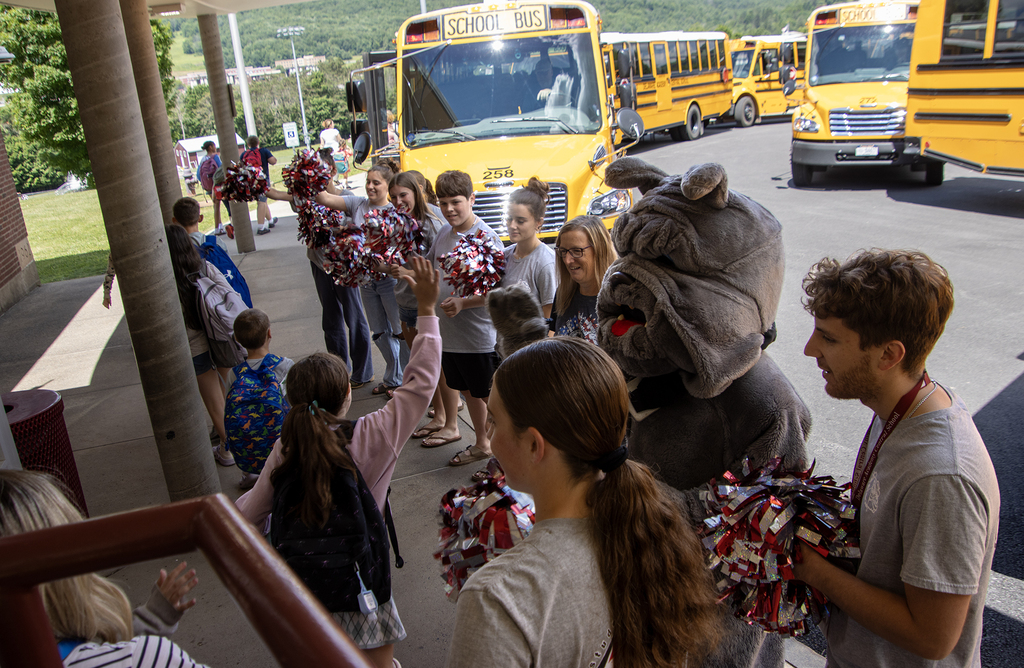 SADD students cheer for elementary students as they leave the school building for the day