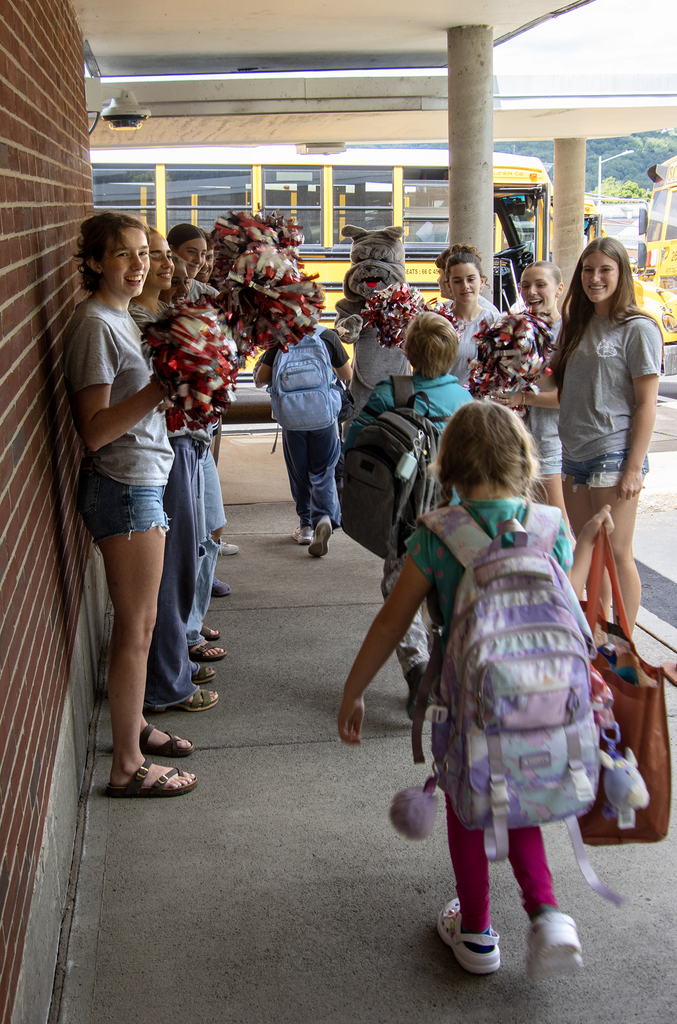 SADD students cheer for elementary students as they leave the school building for the day