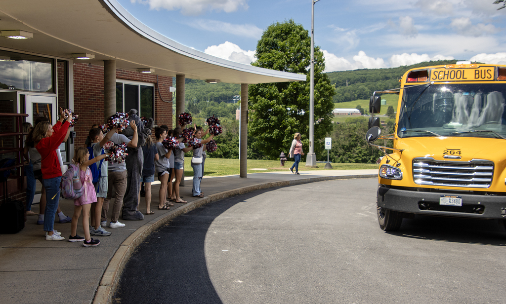 SADD students cheer for elementary students on the bus as they leave the school for the day
