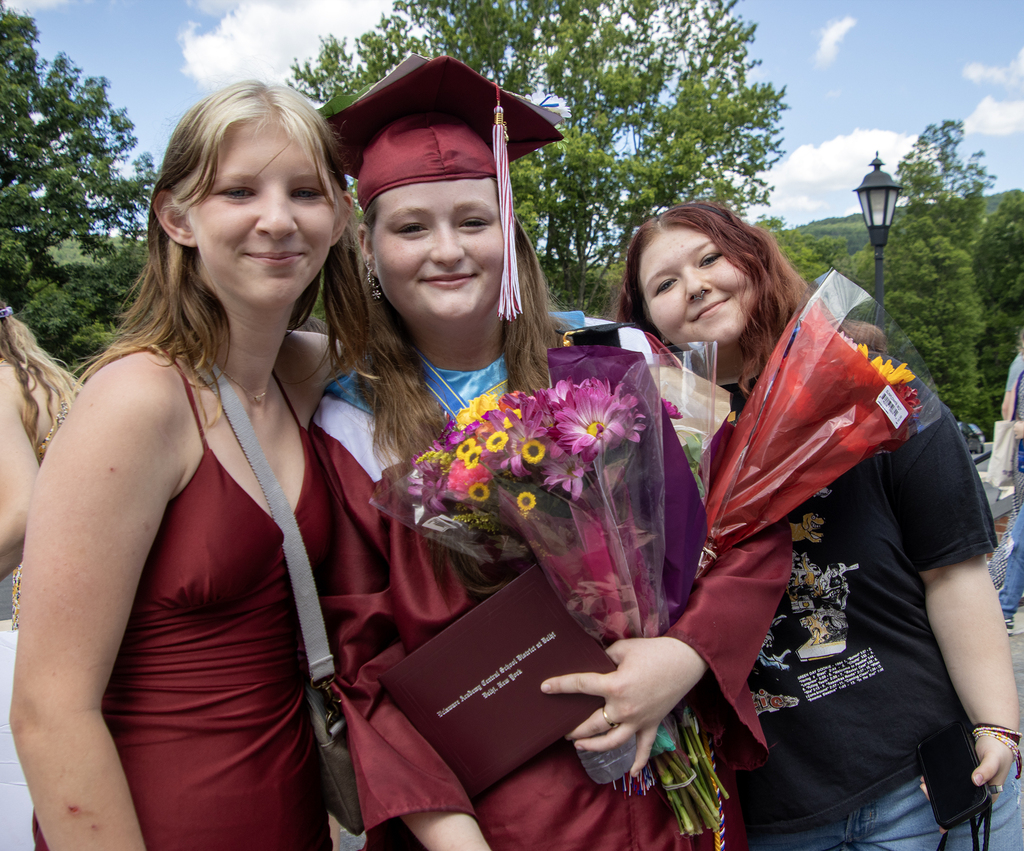 graduate posing with friends