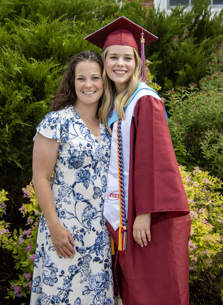 graduate posing with a teacher