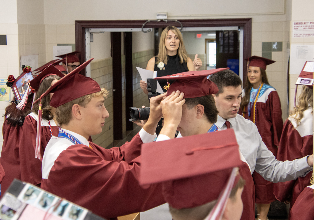 Ms. trask standing on a chair and talking to seniors