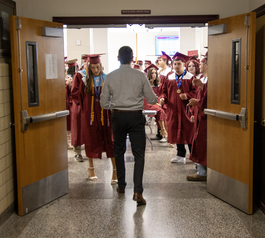 Mr. Layman leading the seniors out of the cafeteria