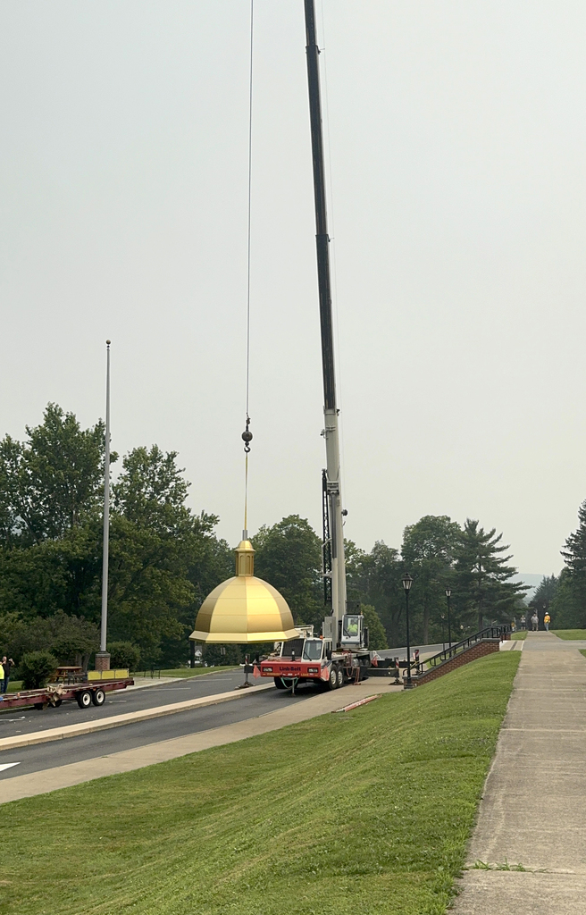 crane hoisting dome from trailer