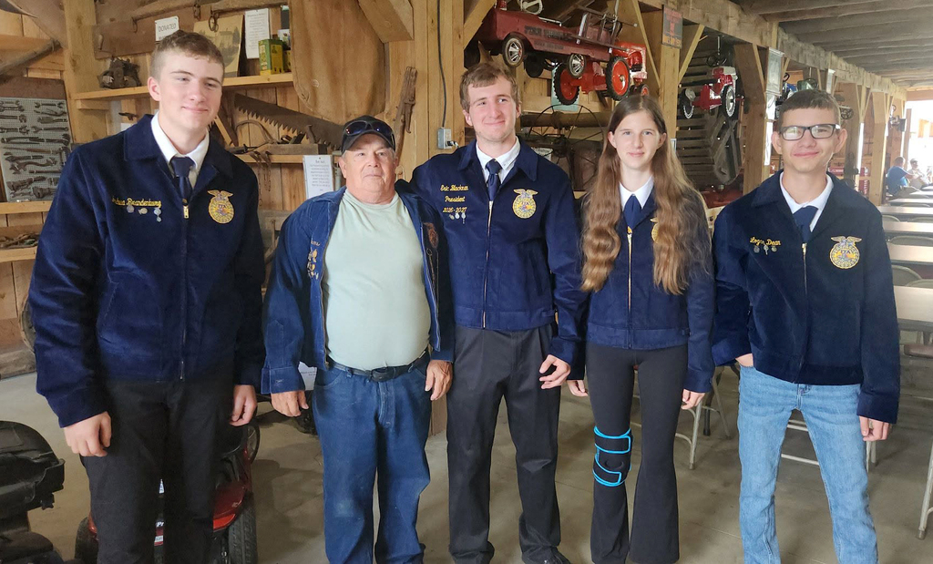 4Delaware Academy FFA members in FFA jackets and one adult in his FFA jacket