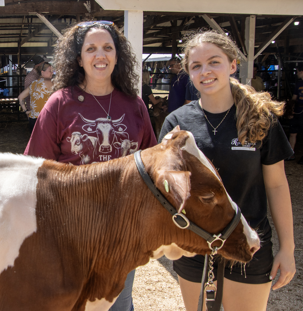 Ms. Werlau and a student pose with a dairy cow